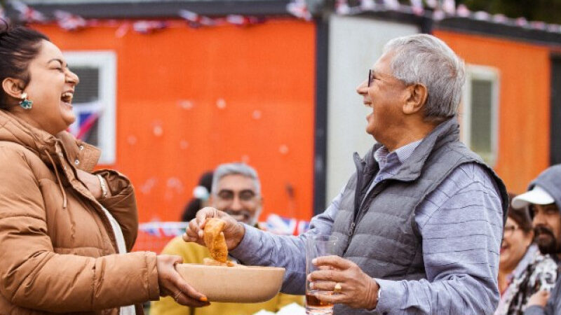 Man and woman sharing food outside